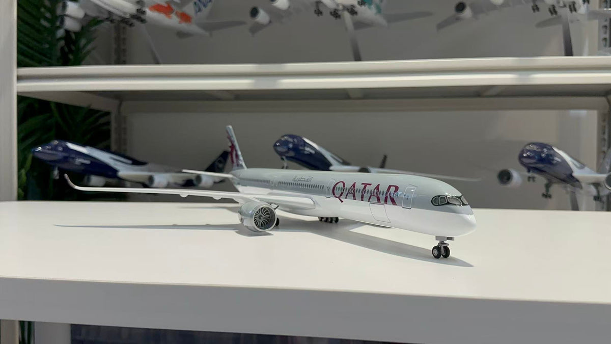Three-quarter view of the Qatar Airways A350-1000 model showing the burgundy titles and engine fan detail